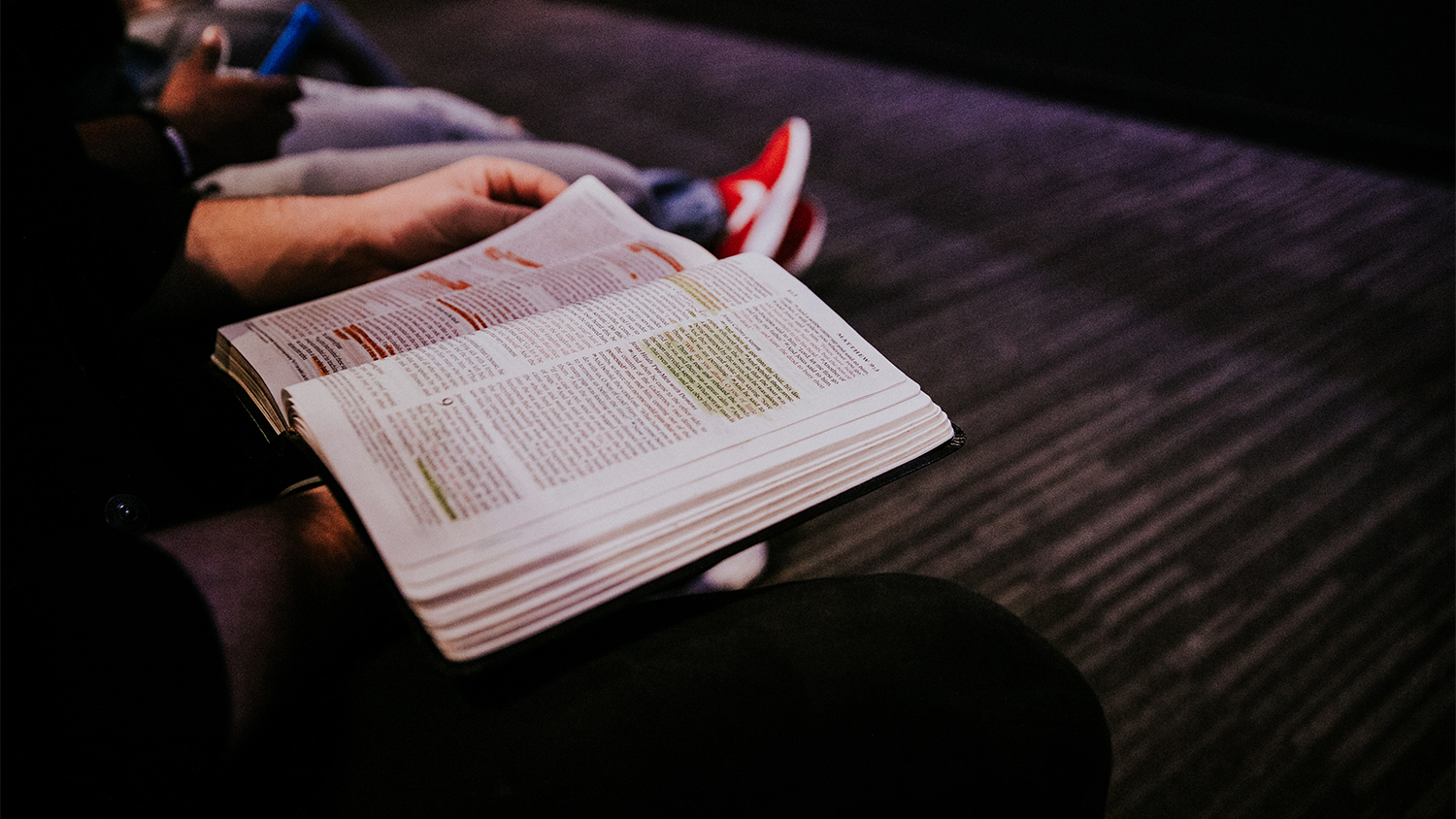 Audience members with open bibles