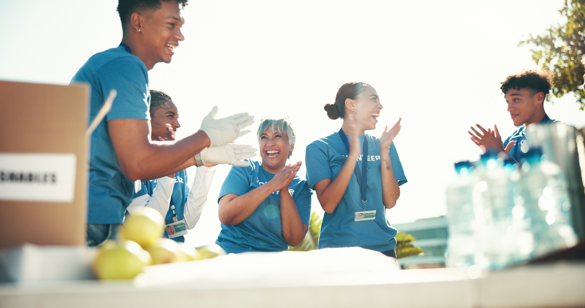 Clapping, volunteers and success for charity, group and celebration for fundraiser, team and mature