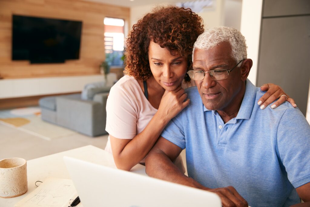 Senior African American Couple Using Laptop To Check Finances At Home